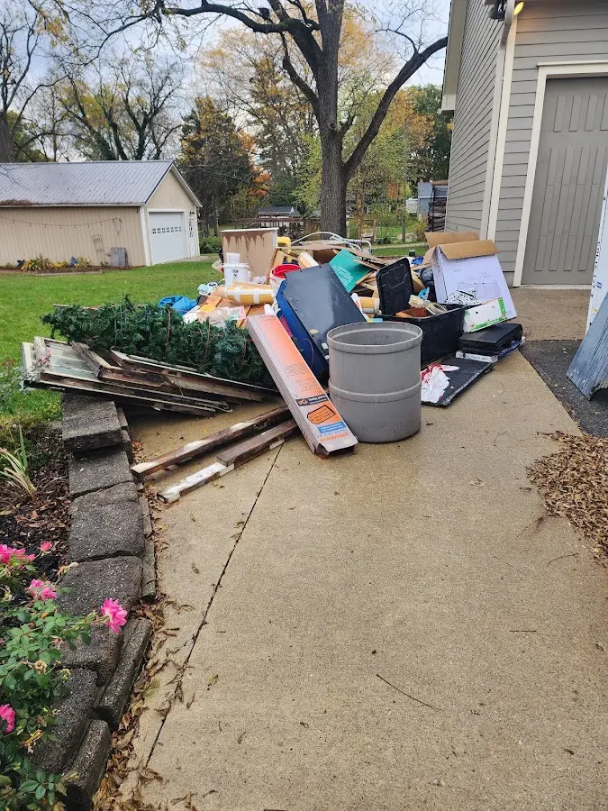 Dumpster being loaded with debris for 10 Yard Dumpster Rental in Weaverville